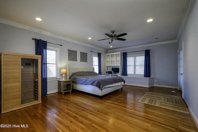 bedroom with hardwood / wood-style flooring, ornamental molding, and ceiling fan