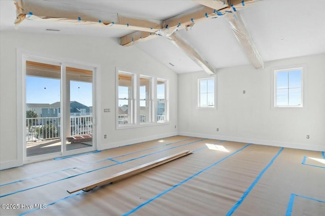 spare room with lofted ceiling with beams and baseboards