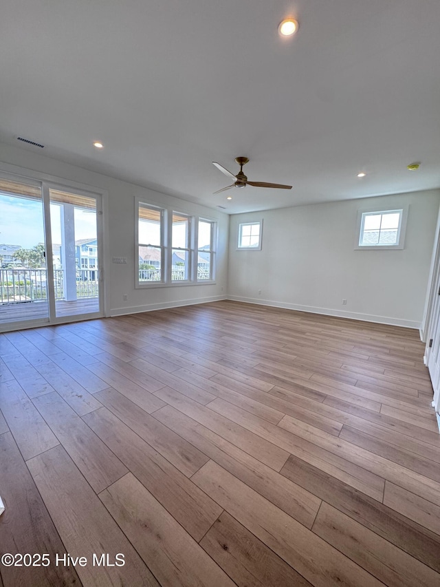 36 Fairmont St, Ocean Isle Beach, NC 28469 - empty room featuring healthy amount of natural light, ceiling fan, light wood finished floors, and recessed lighting