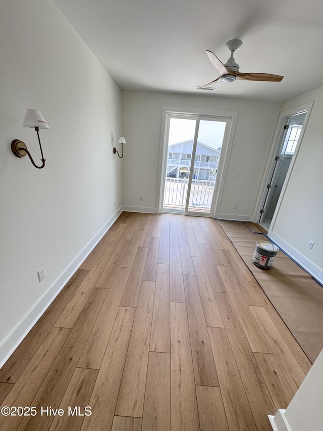 36 Fairmont St, Ocean Isle Beach, NC 28469 - unfurnished living room with wood-type flooring, baseboards, and ceiling fan