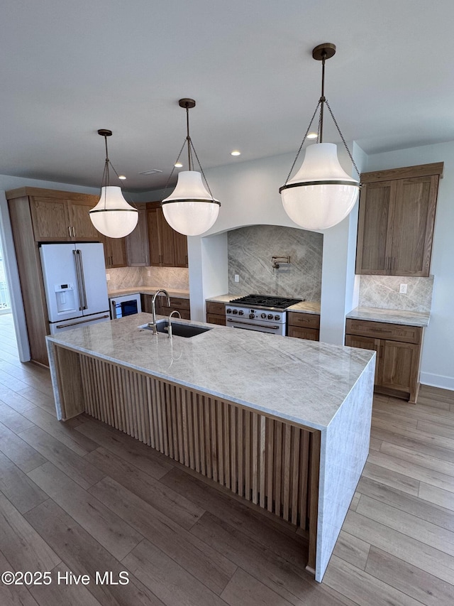 36 Fairmont St, Ocean Isle Beach, NC 28469 - kitchen featuring a sink, high quality appliances, tasteful backsplash, light wood finished floors, and recessed lighting