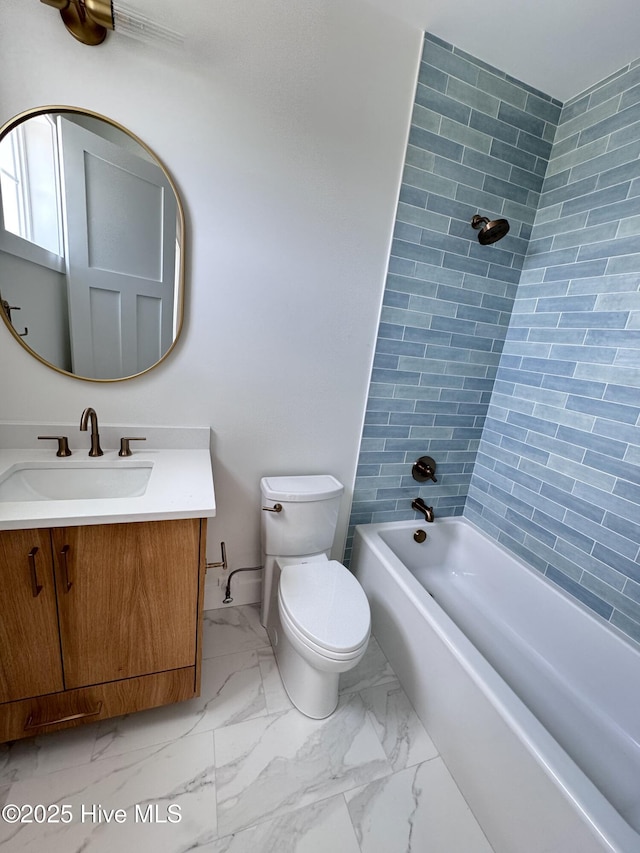 36 Fairmont St, Ocean Isle Beach, NC 28469 - bathroom with marble look tiles, toilet, vanity, and shower / tub combination