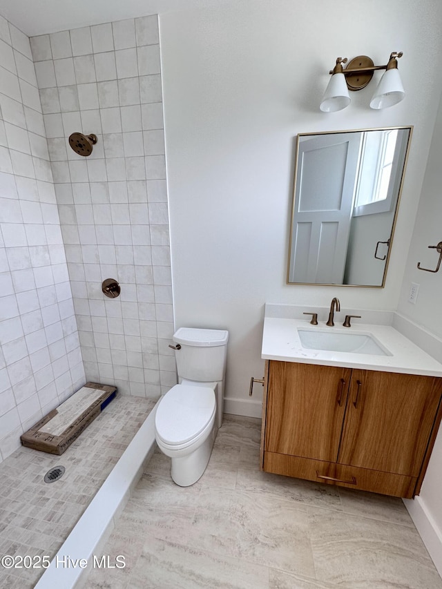 36 Fairmont St, Ocean Isle Beach, NC 28469 - bathroom with toilet, tiled shower, baseboards, and vanity