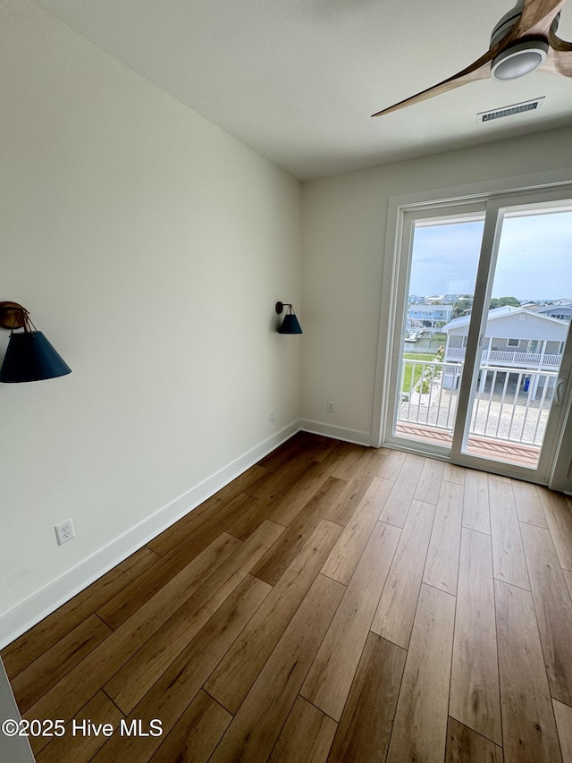 36 Fairmont St, Ocean Isle Beach, NC 28469 - empty room with hardwood / wood-style floors, baseboards, and ceiling fan