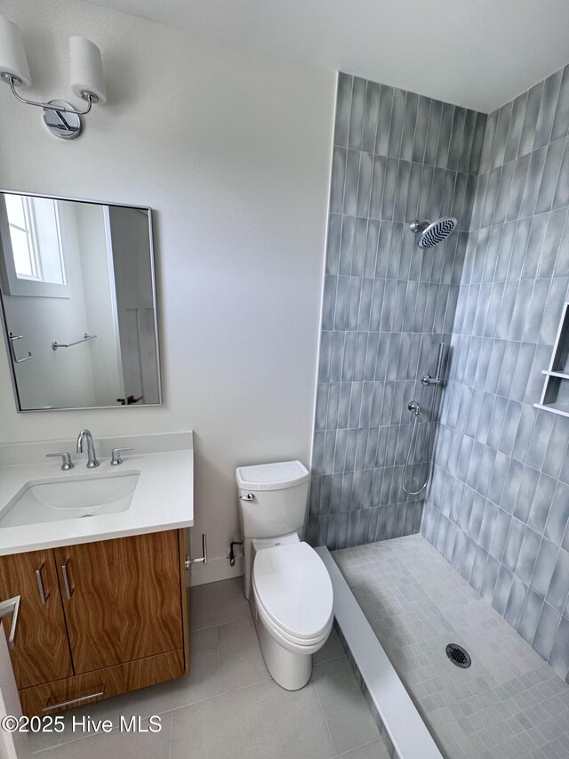 36 Fairmont St, Ocean Isle Beach, NC 28469 - bathroom with tile patterned floors, vanity, toilet, and a tile shower
