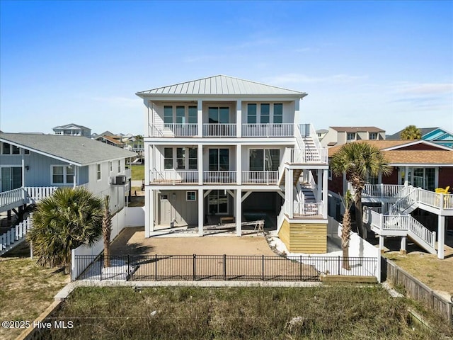36 Fairmont St, Ocean Isle Beach, NC 28469 - rear view of house with stairs, a patio area, a fenced backyard, and a balcony