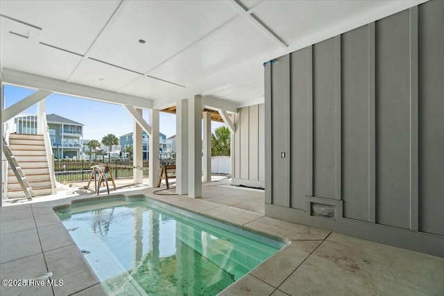 view of swimming pool featuring stairs, a fenced in pool, a patio area, and fence