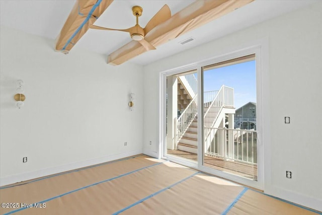empty room featuring visible vents, baseboards, beamed ceiling, wood finished floors, and a ceiling fan