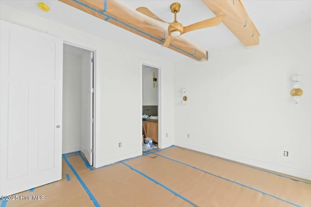 unfurnished bedroom with ensuite bathroom and ceiling fan
