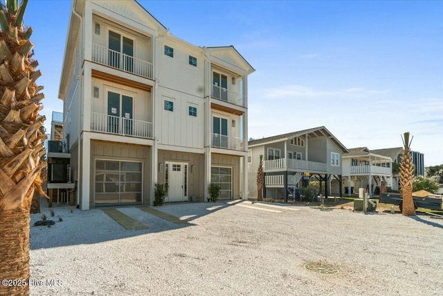 36 Fairmont St, Ocean Isle Beach, NC 28469 - view of front of home featuring board and batten siding, gravel driveway, and a garage