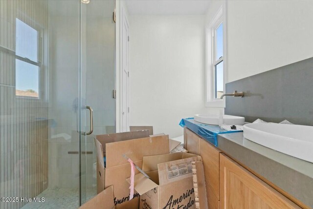 full bath with vanity and a stall shower