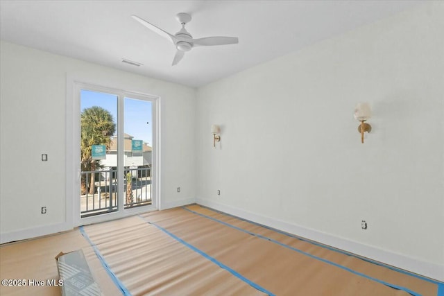 spare room with visible vents, a ceiling fan, baseboards, and light wood finished floors