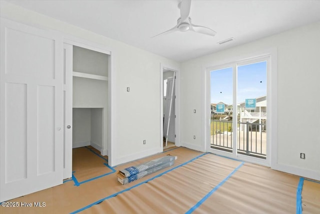 unfurnished bedroom featuring visible vents, baseboards, wood finished floors, a closet, and access to outside