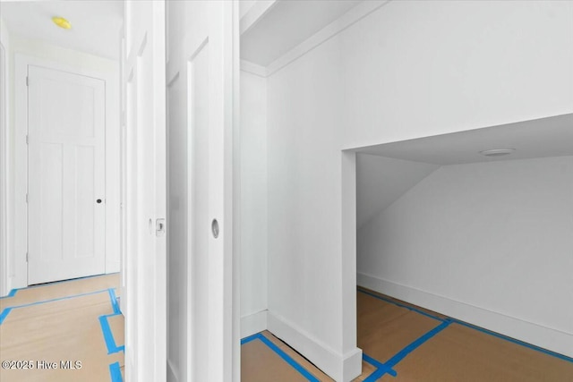 interior space with lofted ceiling and baseboards