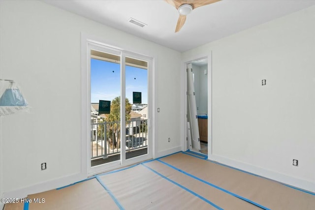 interior space featuring visible vents, baseboards, a ceiling fan, and access to outside