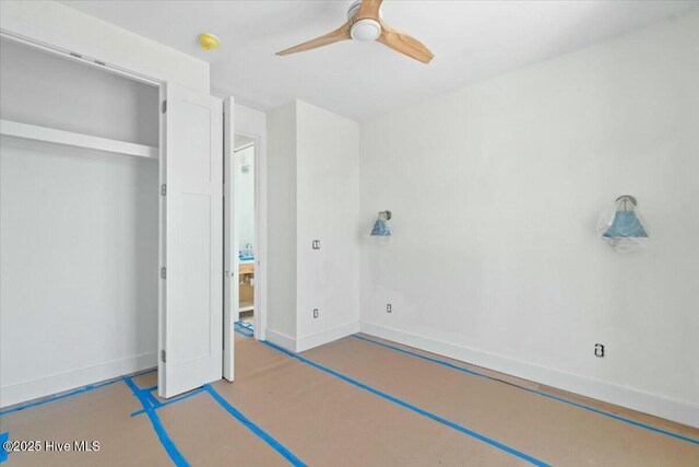 unfurnished bedroom with a ceiling fan and baseboards