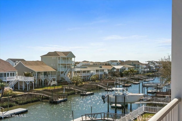 dock area featuring a residential view and a water view