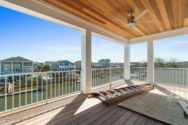 deck featuring a residential view and ceiling fan