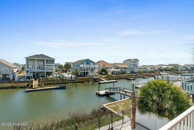 view of water feature featuring a dock and a residential view
