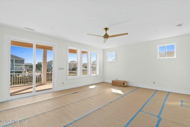 interior space featuring visible vents, baseboards, and ceiling fan