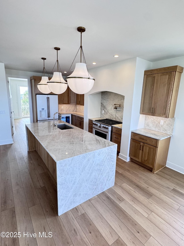 36 Fairmont St, Ocean Isle Beach, NC 28469 - kitchen with a sink, white appliances, decorative backsplash, light wood-style flooring, and baseboards