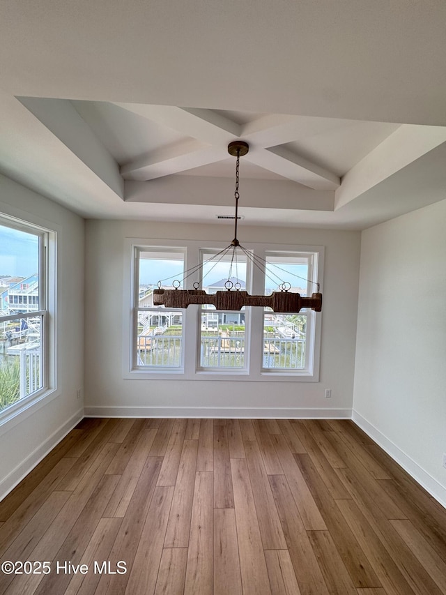 36 Fairmont St, Ocean Isle Beach, NC 28469 - unfurnished dining area featuring hardwood / wood-style floors, baseboards, a chandelier, a raised ceiling, and beamed ceiling