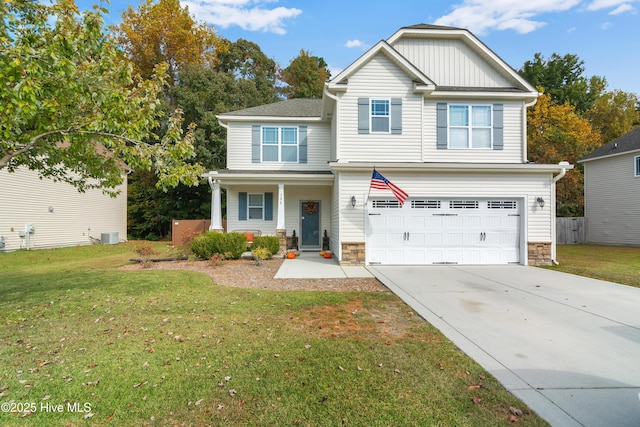 view of front of property featuring a garage, central AC, and a front yard