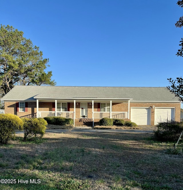 ranch-style home featuring a porch and a garage