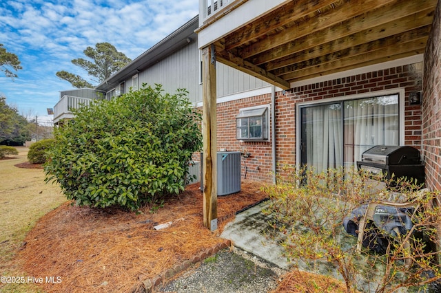 exterior space featuring a grill and central AC