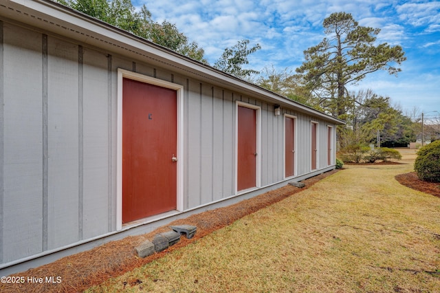 view of exterior entry with a lawn