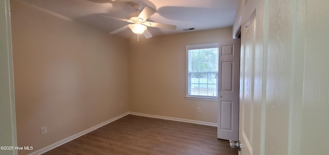 empty room with hardwood / wood-style flooring and ceiling fan