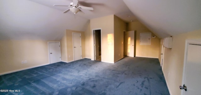 additional living space featuring vaulted ceiling, ceiling fan, and dark colored carpet