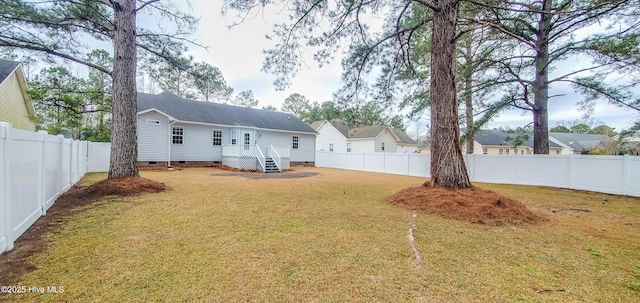 rear view of property with a yard