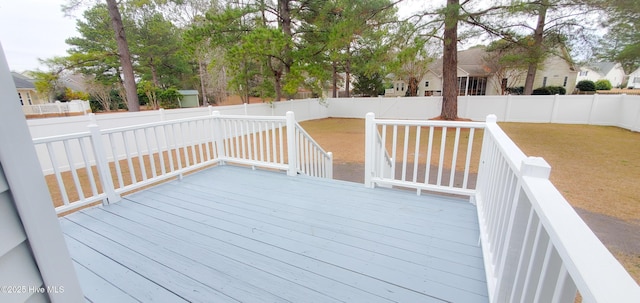 wooden terrace with a lawn