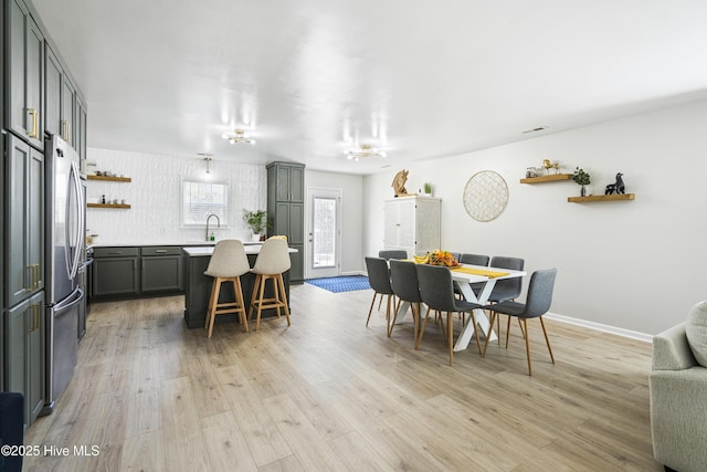 dining area featuring sink and light hardwood / wood-style floors