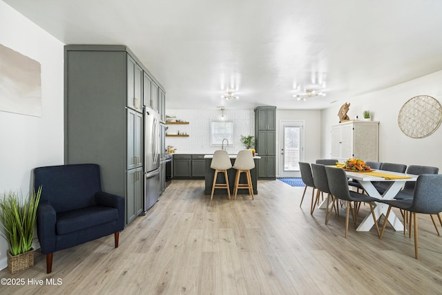 dining space featuring sink and light hardwood / wood-style flooring