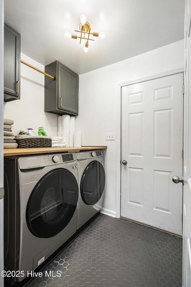 laundry area featuring cabinets and washing machine and clothes dryer