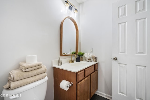 bathroom featuring vanity and toilet