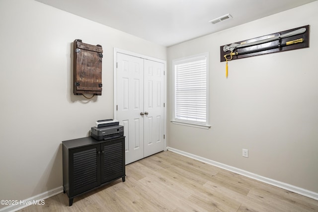 bedroom featuring light wood-type flooring and a closet