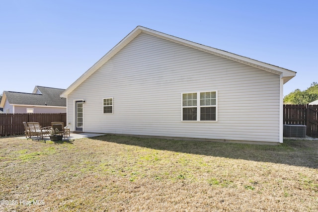 back of property with a yard and a patio area