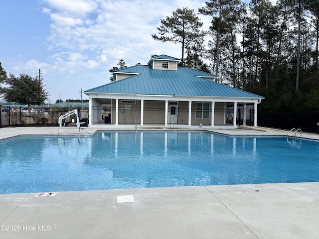 community pool featuring a patio area and fence