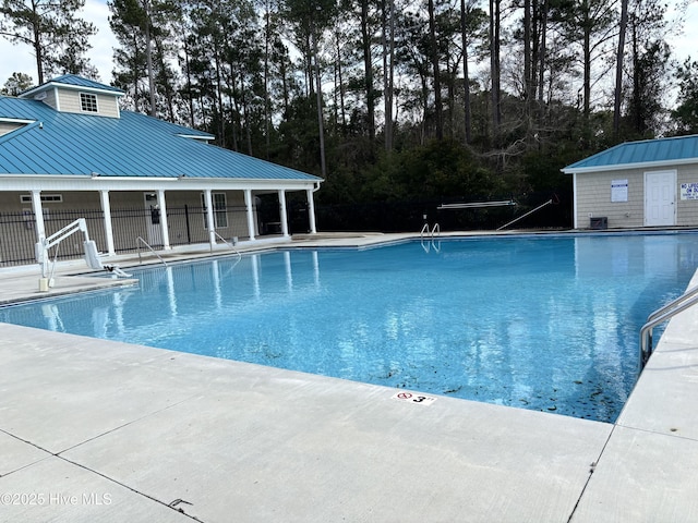 pool featuring fence and a patio