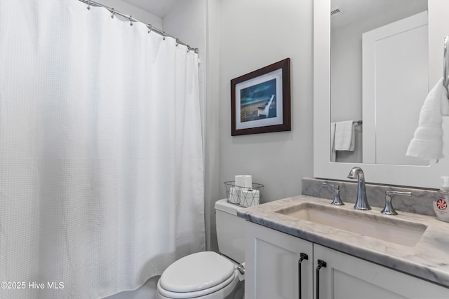 full bath featuring vanity, toilet, and visible vents