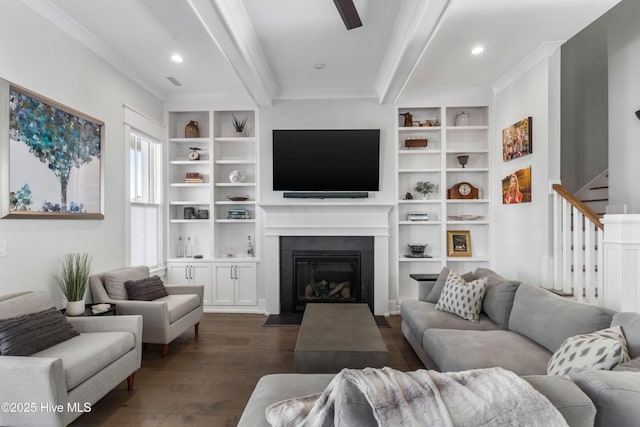 living room with a fireplace with flush hearth, beam ceiling, dark wood finished floors, stairway, and crown molding