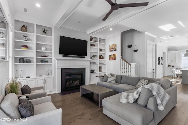 living room featuring dark hardwood / wood-style floors, ceiling fan, beam ceiling, and crown molding