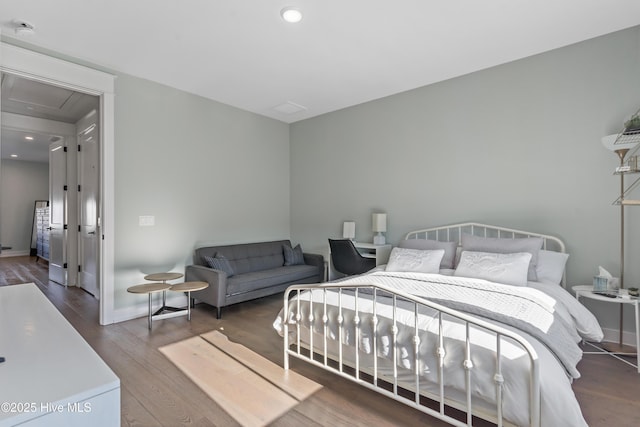 bedroom with recessed lighting, baseboards, and wood finished floors