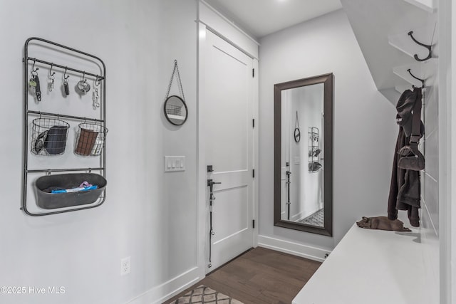 entryway featuring dark wood-type flooring and baseboards