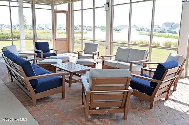 sunroom featuring a water view and a healthy amount of sunlight