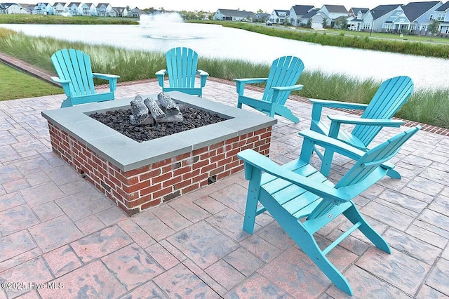 view of patio / terrace with a water view and an outdoor fire pit