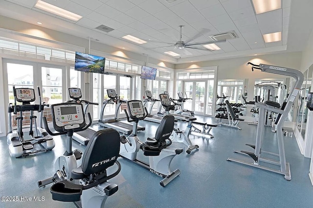 gym featuring a paneled ceiling, french doors, and ceiling fan